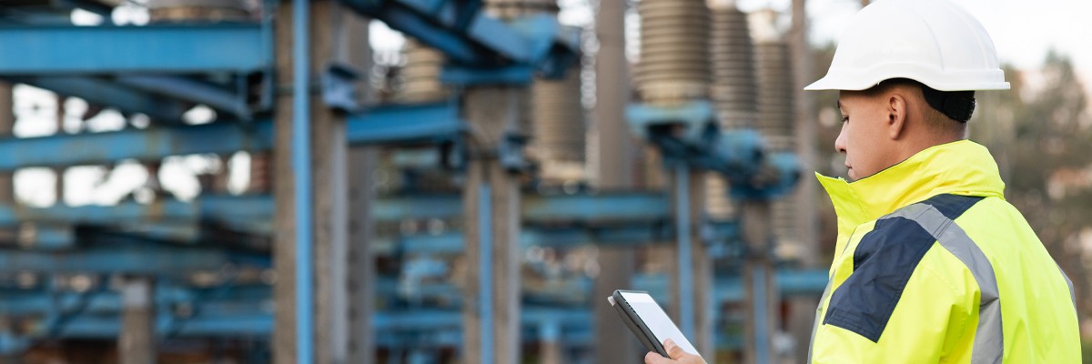 Utilities worker uses tablet device while on-site