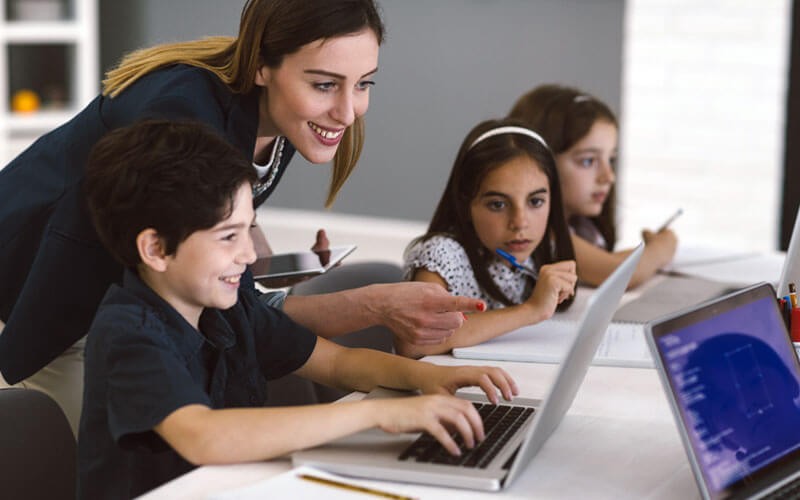 Devices using Windows 11 being used in computer lab by teachers and students