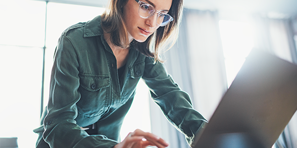 Business woman downloading Insight's Agile Awareness to Action Canvas Workbook to her laptop computer