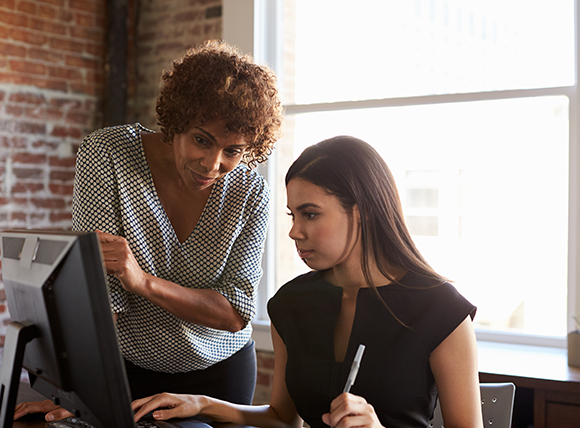Two office women learning 