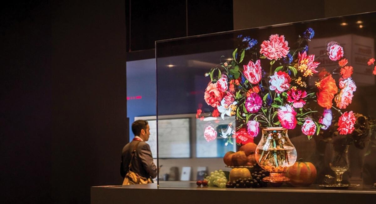 Man looks at transparent OLED display