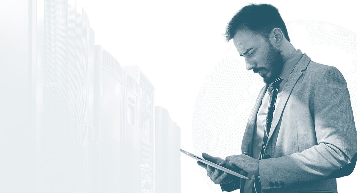 Man in business suit looking down at computer tablet