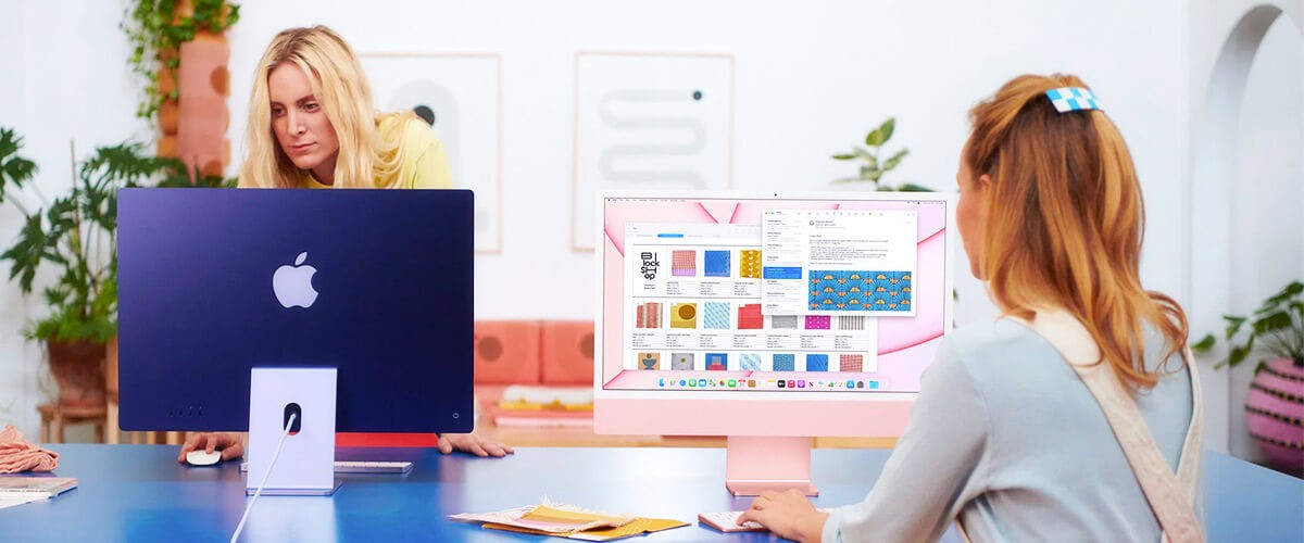 Business woman using Mac computers to handle their small business challenges