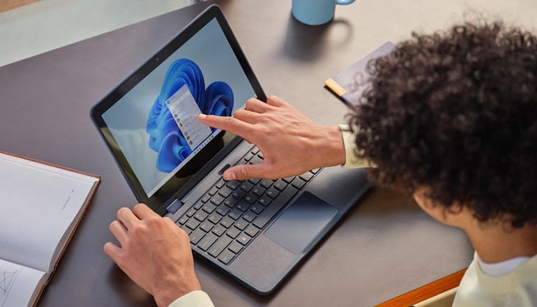 Man using laptop for work at home. Windows 11, Device deployment, device manageability, deployment and manageability 