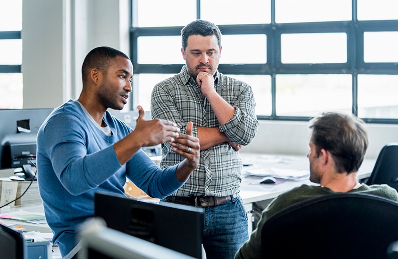 Three business men discussing technology Security in the cloud for your data center and network architecture