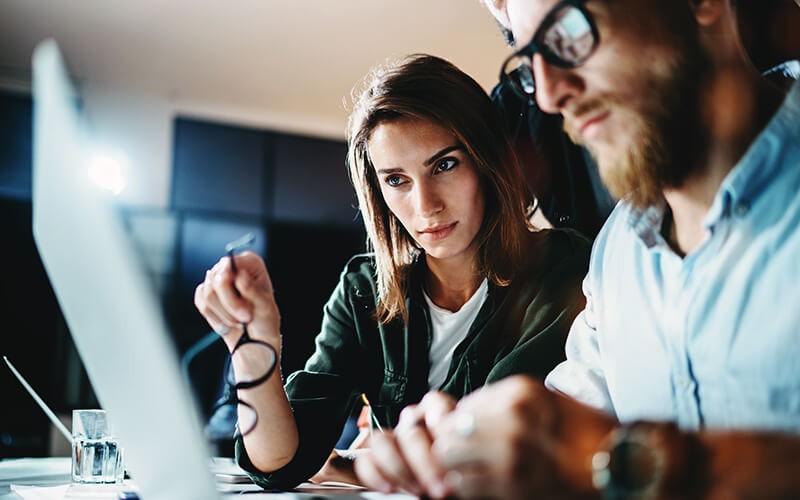 Download the EA software onto your system(s) Businessman and businesswoman collaborating together on a laptop