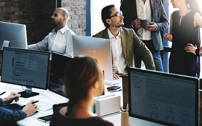 Read this guide to grant additional users access Business team collaborating at someone's desk