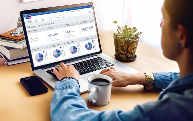 Cloudyn is the only multicloud monitoring and optimization solution Woman typing on laptop with Cloudyn monitoring solution displayed