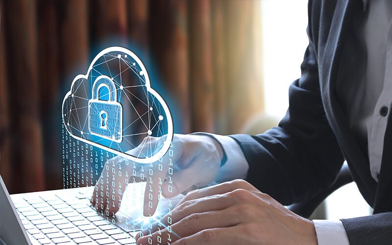 Falcon Cloud Security Posture Management Person using a laptop with cloud security icon