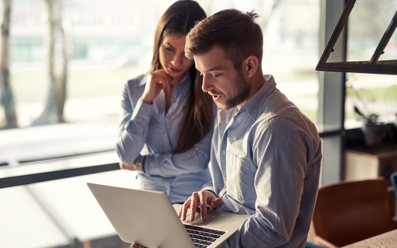 Control data distribution and cloud environments Coworkers collaborating over laptop device