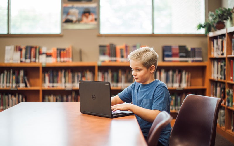 The right technology can help students learn, connect with each other Student using Dell laptop device