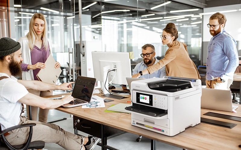 Epson printers Group of creators working in office with Epson printer
