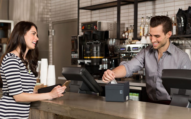 Coffee shop employee printing receipt on Epson printer