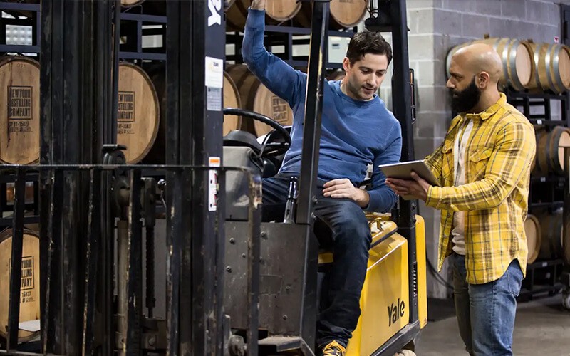 The perfect devices for your teams Teammates working together using a tablet