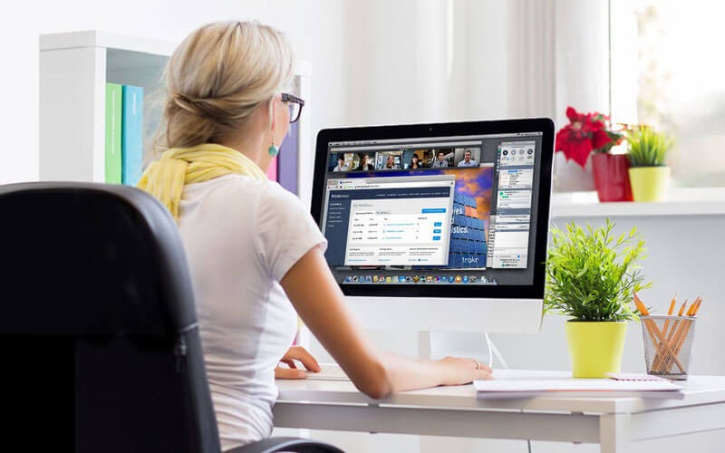 LogMeIn Rescue Woman working at open desk with laptop