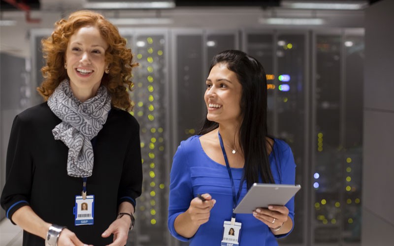IT team Two women smiling in data center