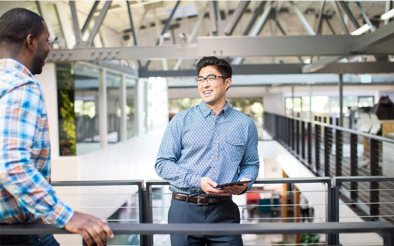 Business man smiling while holding tablet device