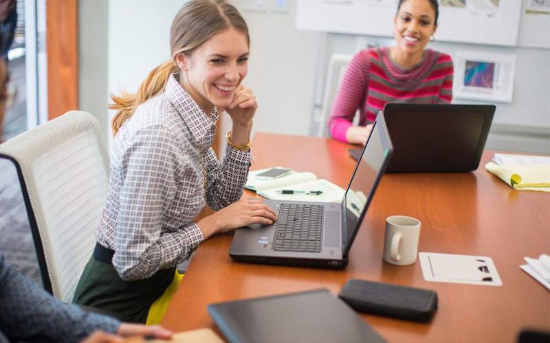 Business meeting with women using desktop devices