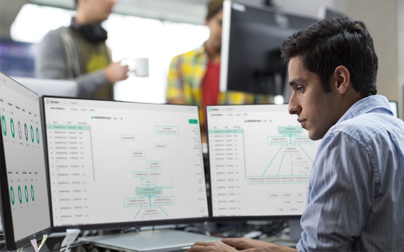 Manage cloud operations and data virtualization Employee using multiple monitors and desktop device
