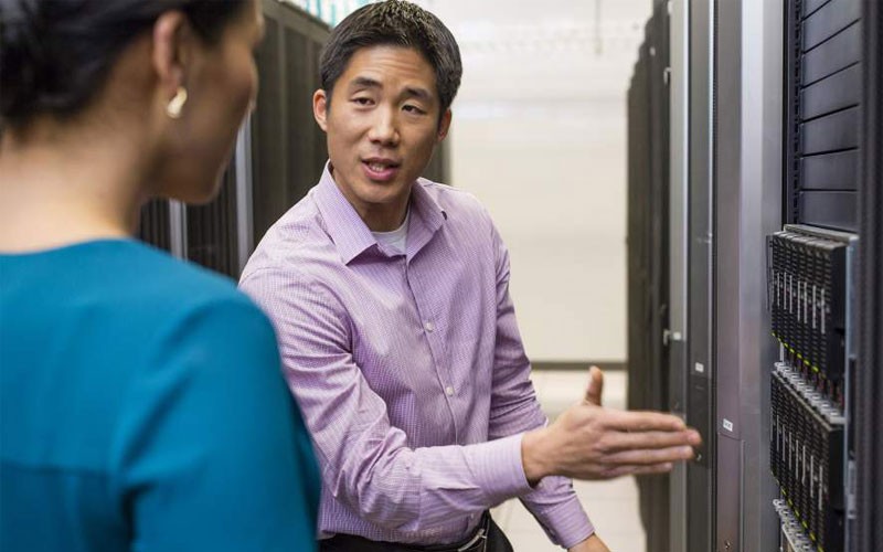 Data center operations Man and woman in IT server room