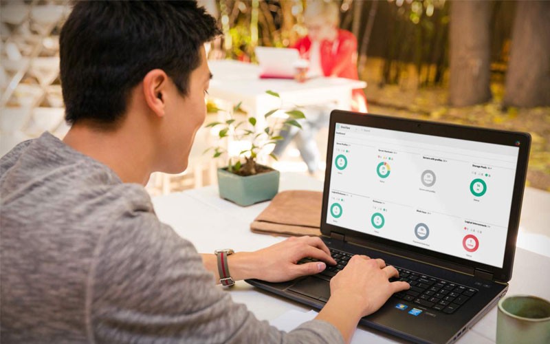 Automate your data center operations Man using automating software while on laptop device remotely