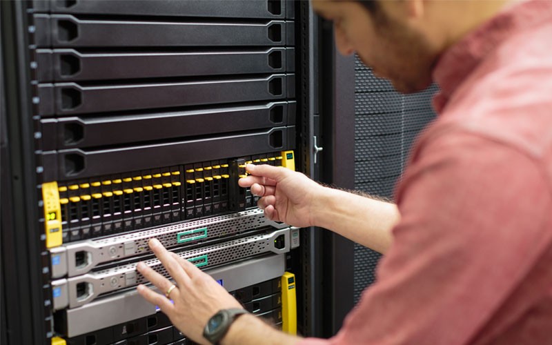 Data storage solutions close-up of IT technician working in server room
