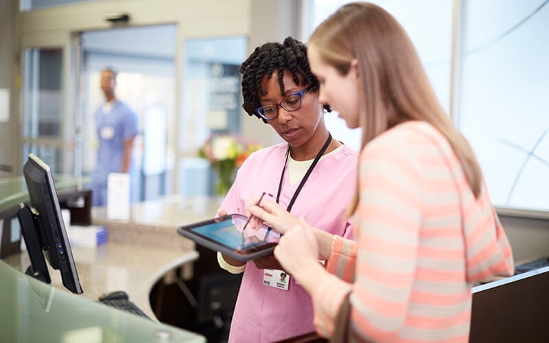 Technology specific to your industry Nurse with patient using HP healthcare tablet device