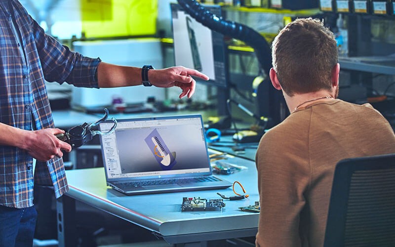 A powerful computer for rendering Man using his laptop at work