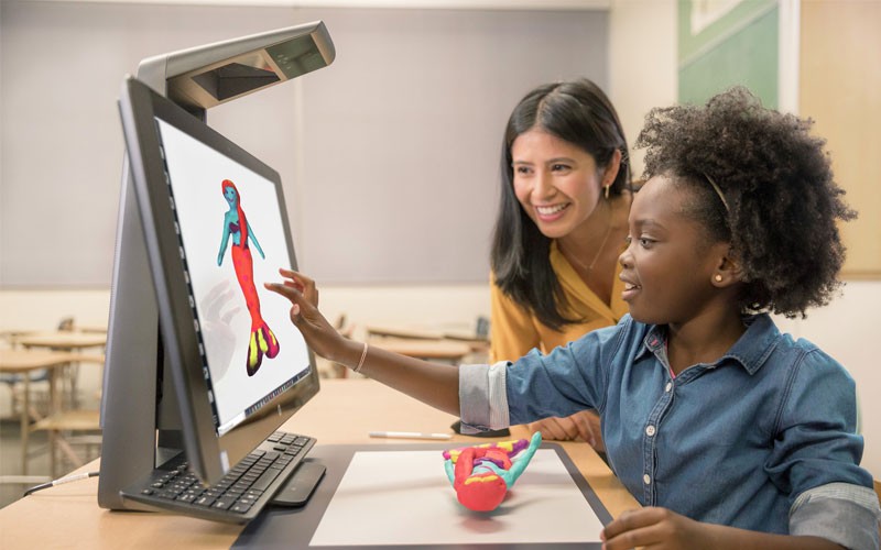 Operate more efficiently and cut printing costs. Teacher and student using HP product in classroom