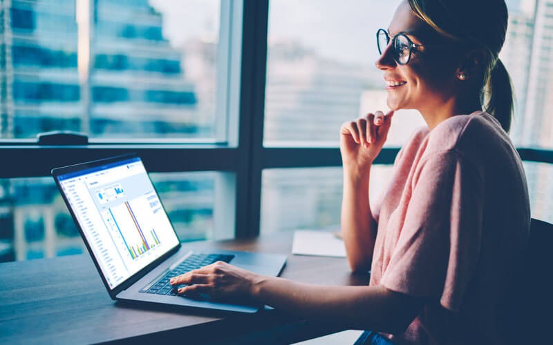 IBM Cognos find data sources Woman using laptop displaying IBM Cognos Analytics