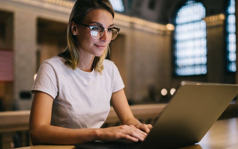 MaaS360 with Watson protects public and private apps Woman using laptop device