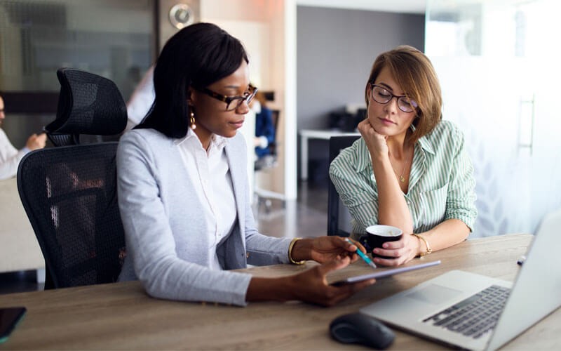 Image API Paperless Agency is powered by Axiom Digital Library or Axiom Pro Two woman working on technology