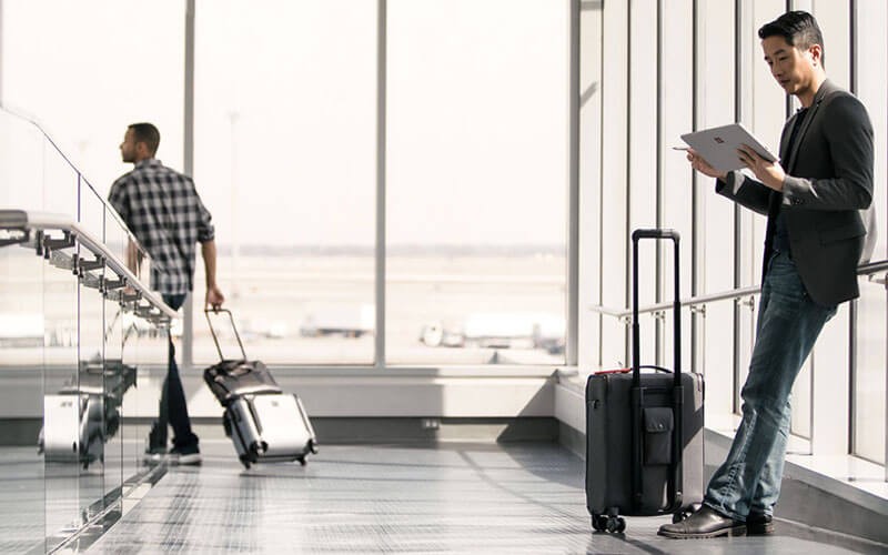 Microsoft Dynamics 365 Man working on Surface device in airport