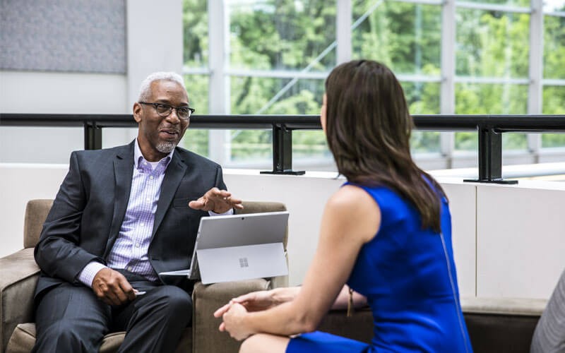 Microsoft Enterprise Mobility + Security Two people having business meeting