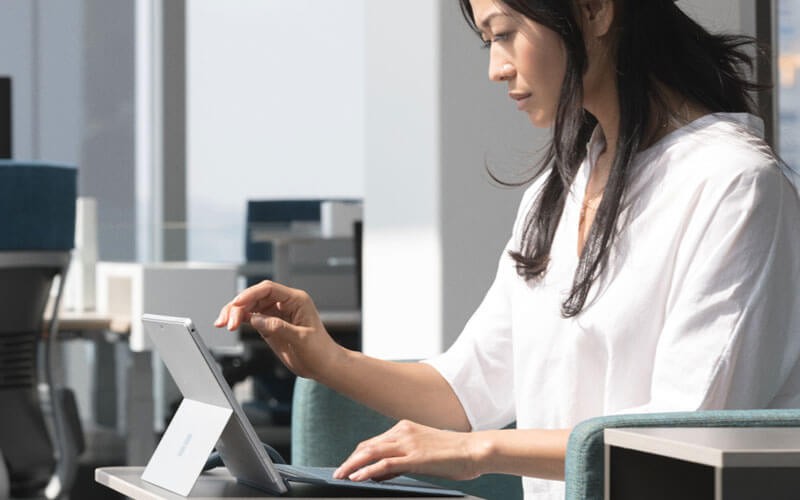Modernize you portfolio with Azure Woman working on Microsoft Surface device