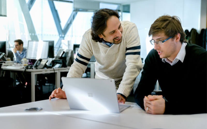 Microsoft offer customizable licensing options for both software and hardware Two men working together