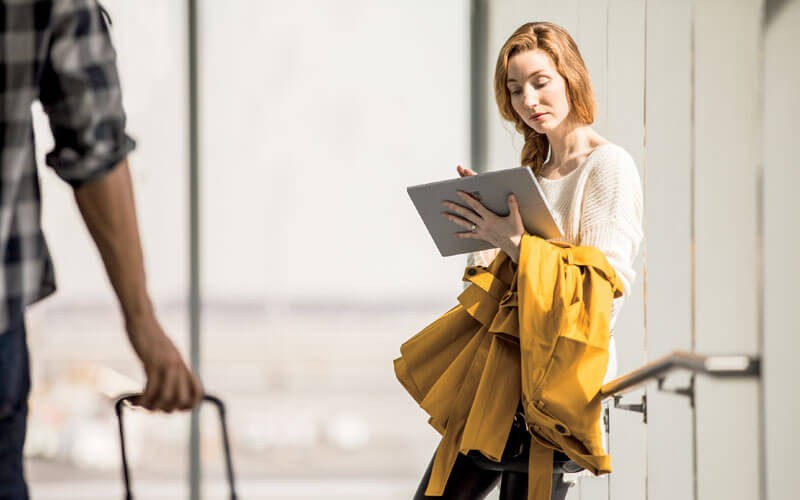 Enterprise Mobility + Security E3 Woman using Microsoft Surface at airport