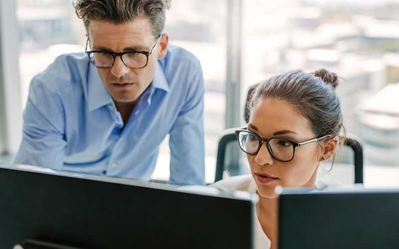 Secure email storage Two coworkers looking over desktop screen