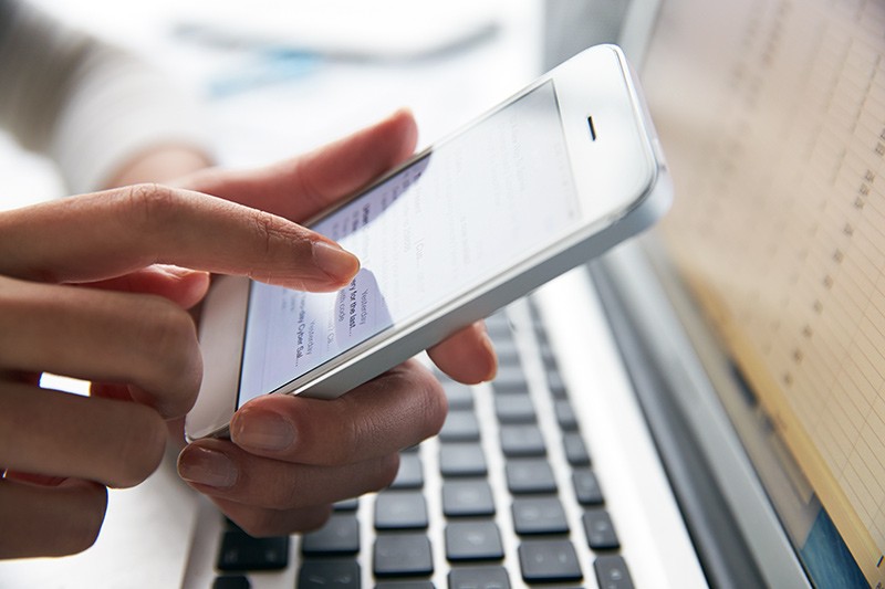 Open your phones to allow for the services you want Businessman on smart phone near laptop computer