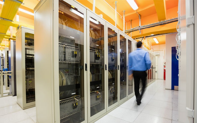 MiStealth by Mitel Man walking through data center