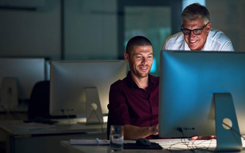 VoIP phone and mobile data security solutions Two men working together on computer