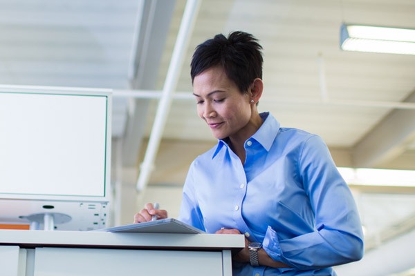 On premise or cloud deployment foundations Business professional on tablet at office desk