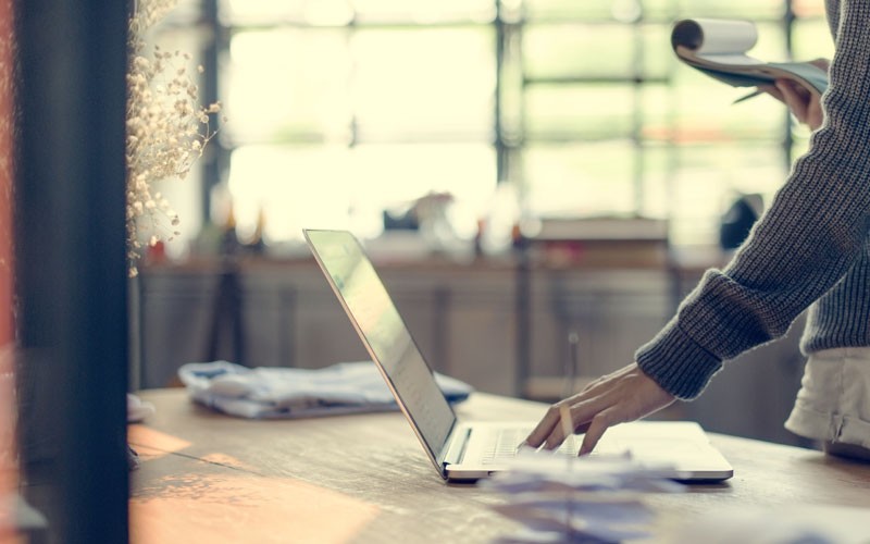Nutanix Prism operations Woman clicking button on laptop