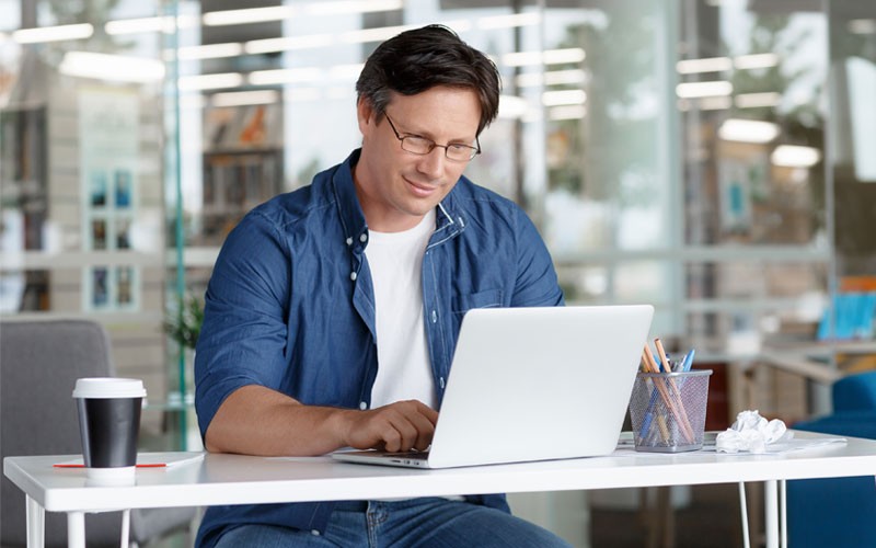Enterprise applications gives you stability and performance Business man using laptop at desk