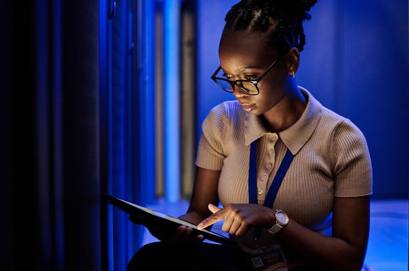 female-it-engineer-using-tablet-in-modern-server-room female-it-engineer-using-tablet-in-modern-server-room