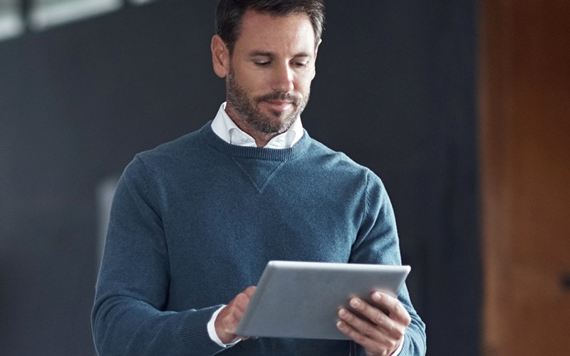 Quest reporting solutions Man looking at tablet device