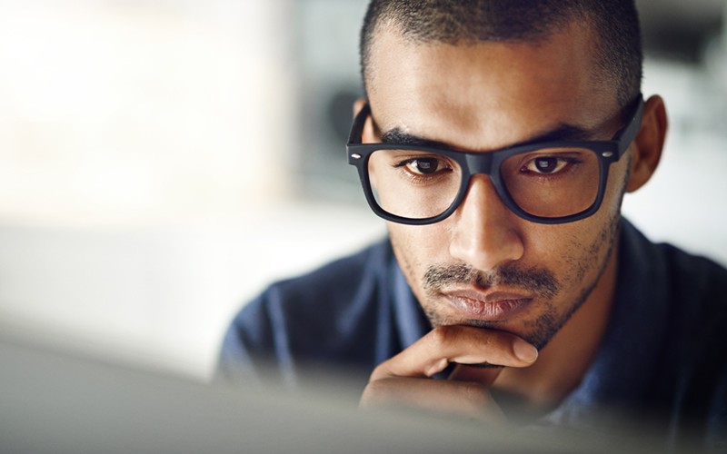 One Identity access management software Close up of male looking at desktop screen
