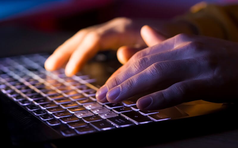 Person typing on laptop