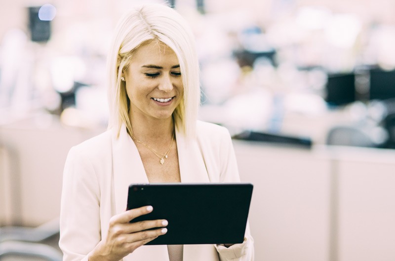 View system-wide deployments Business manager viewing report on operational intelligence from tablet computer