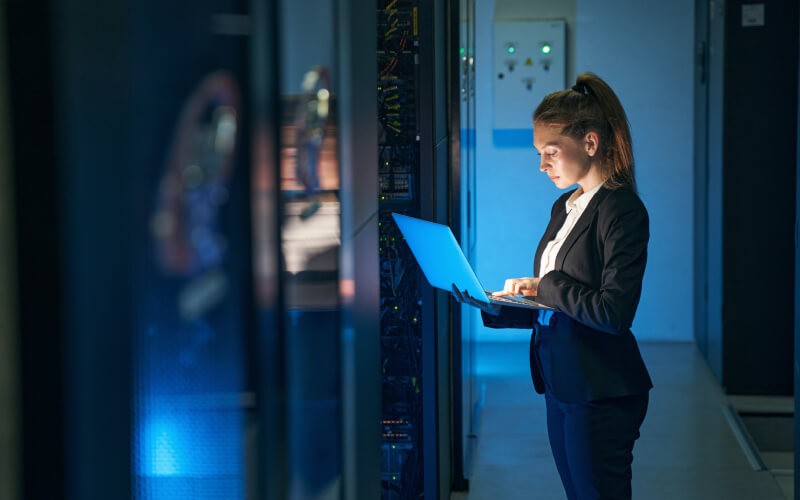 Cloud migration at your pace Woman standing holding her laptop